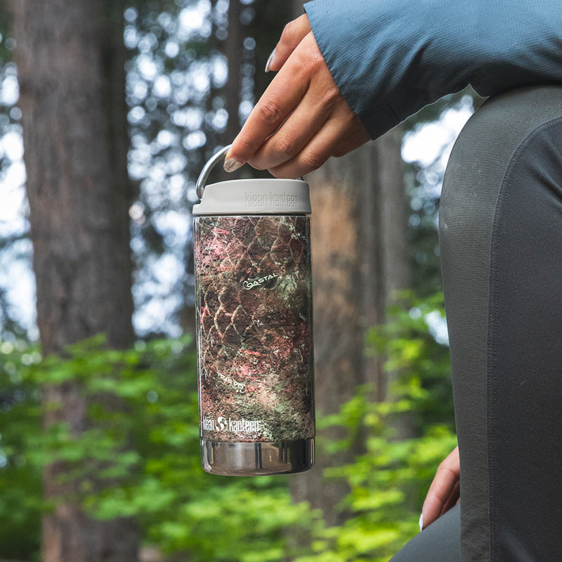 12oz-tkwide-with-twist-cap-mossy-oak-f6 12oz_tumbler_mossyoak_rainbowtrout_hand_closeup_square.jpg